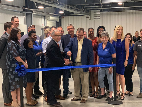 Ribbon cutting ceremony at grand opening, with Mayor David Briley, Fair Board Chair Ned Horton, and crowd of observers